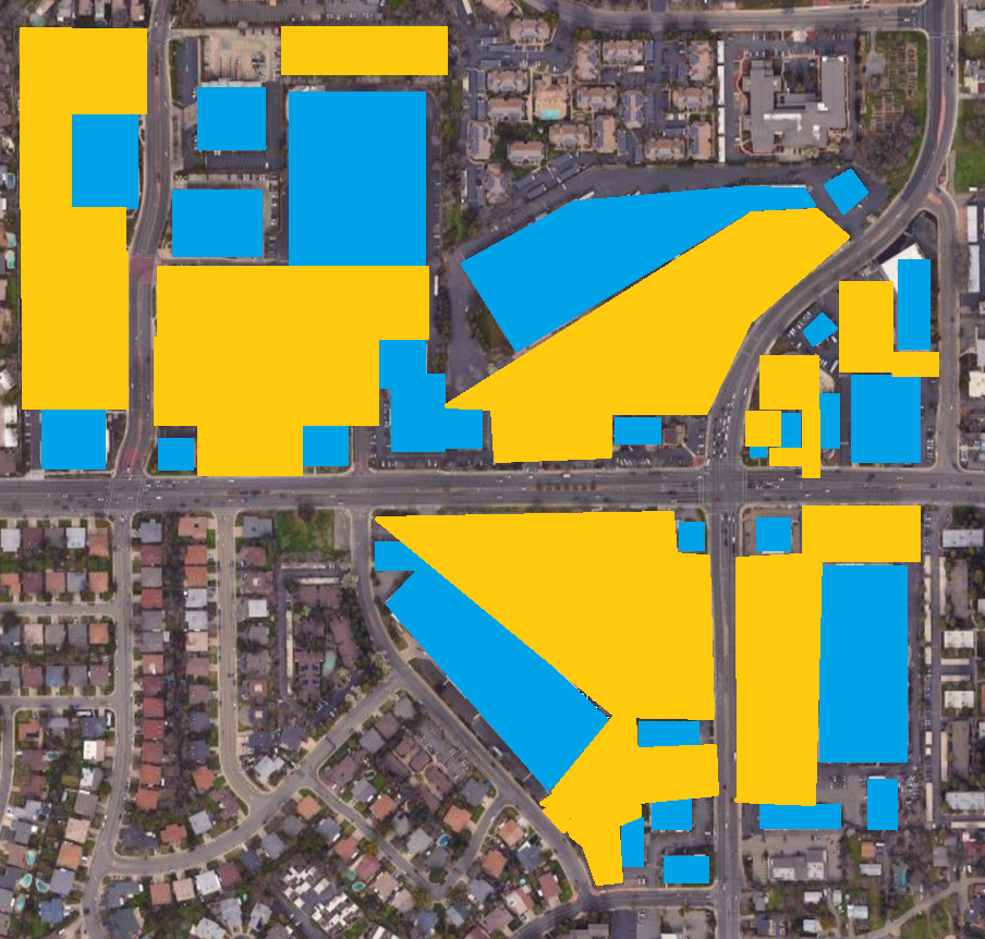 A top down satellite view of a suburban shopping center, yellow is parking and blue is buildings, more than half of the area is parking